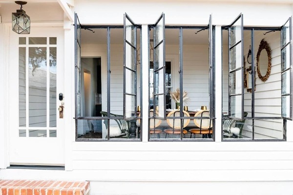 A unique dining area seating 8 with the original vintage windows allowing for an open meal with friends or family!