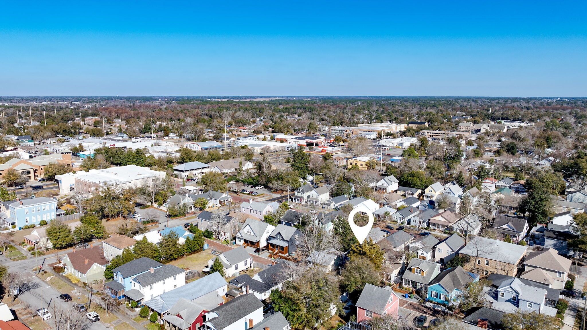 A residential area with houses, streets, and a large building in the center.
