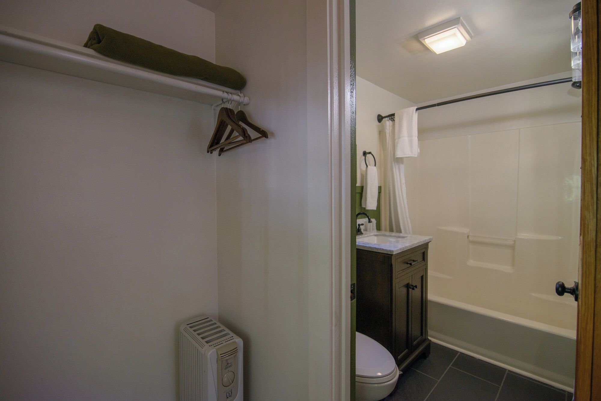 A bathroom with a toilet, sink, and shower.