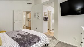 A bedroom with a bed, a TV, and a door leading to another room. - Las Vegas Home w/ Covered Patio ~ 5 Mi to Strip! (Las Vegas)