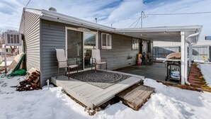 A single-story house with a covered patio area, a front door, and a garage. - Covered Patio, Gas Grill & Yard: Sheridan Home! (Sheridan)