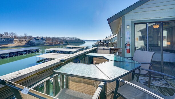 A glass-enclosed outdoor area with a view of a river and docked boats. - Village of Four Seasons Lake Condo w/ Pool Access! (Village of Four Seasons)