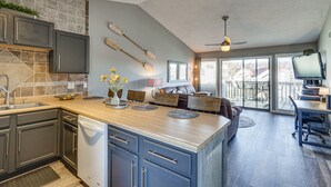 A spacious kitchen with a large island, built-in appliances, and a dining area with a view. - Village of Four Seasons Lake Condo w/ Pool Access! (Village of Four Seasons)