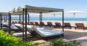 On the beach, sun-loungers