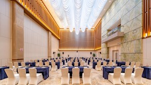 A large conference room with rows of tables and chairs, a high ceiling with draped fabric, and marble walls. - Holiday Inn Express Beijing Conference Center by IHG (Beijing)