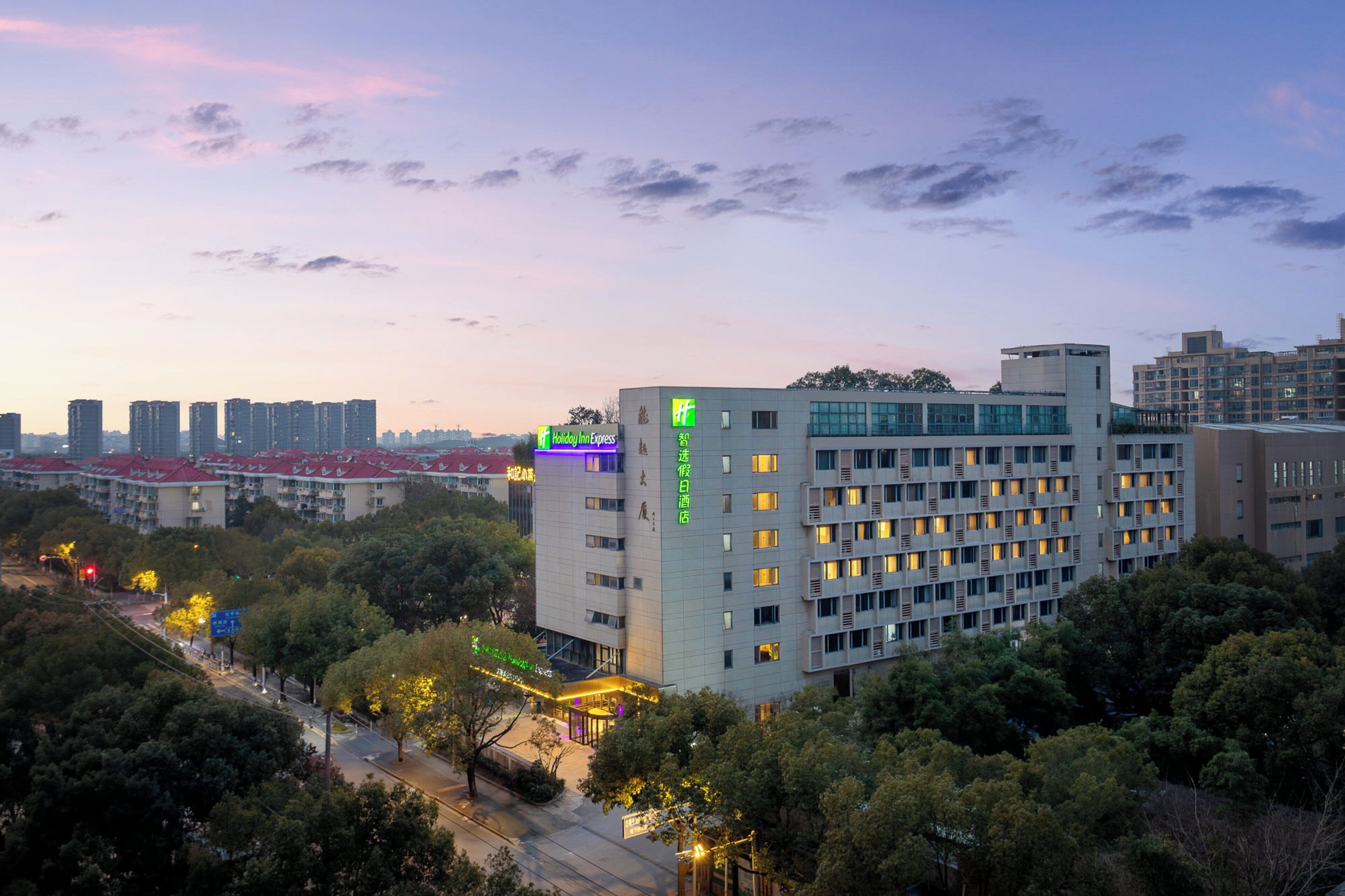 A multi-story hotel with a modern design, featuring a prominent Holiday Inn Express sign.