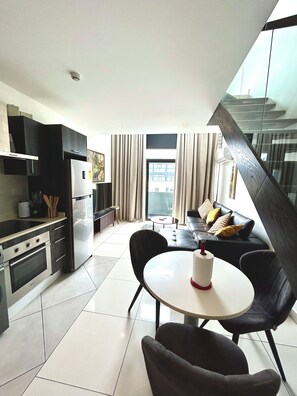 Luxury Apartment, 1 Bedroom | Living area | 65-inch Smart TV with digital channels, Netflix, streaming services - Embassy Gardens Apartment (Accra)