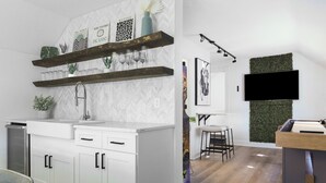 A modern kitchen with white cabinetry, wooden shelves, and a built-in TV.