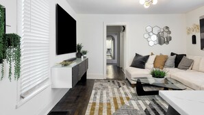 A modern living room with a sofa, coffee table, and decorative wall art.