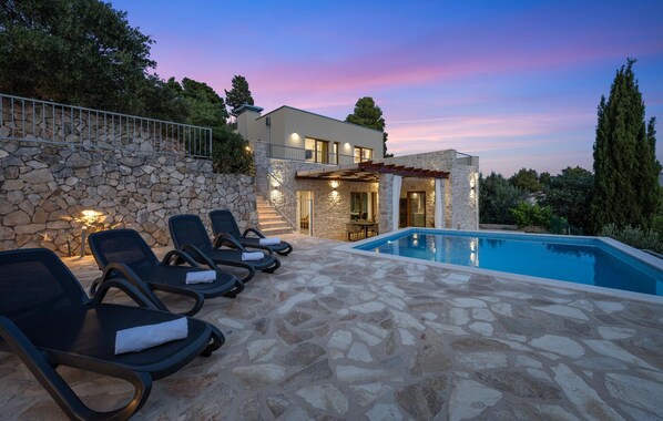 Relax by the pool surrounded by a serene atmosphere and comfortable lounge chairs.