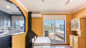 A kitchen with a view of the sea, a dining area, and a balcony. - Apartment 'Mimosa' with Sea View, Wi-Fi and Air Conditioning (L'Escala)