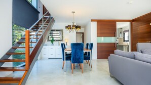 A modern interior with a staircase, dining area, and sofa. - Villa 'Oasis N'Aguait' with Private Pool, Wi-Fi and Air Conditioning (Cala Rajada)