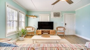 A living room with a TV, two chairs, a sofa, a ceiling fan, and a potted plant. - The Salty Point....a waterfront fishing cottage with kayaks, ping pong and more! (Franklin)