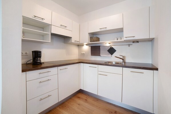 Fridge, stovetop, dishwasher, coffee/tea maker