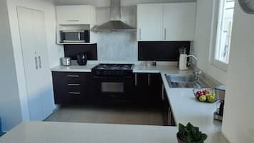 Casa urbana | Cocina privada | Microondas, tetera eléctrica y utensilios de cocina