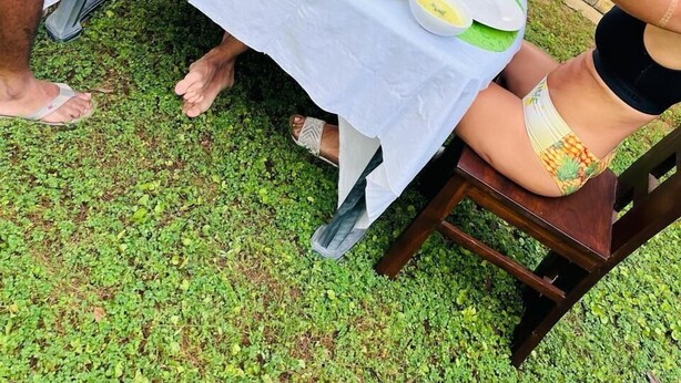 A dining table set outdoors with various dishes and drinks. - Ibeeza Motel (Batigama)
