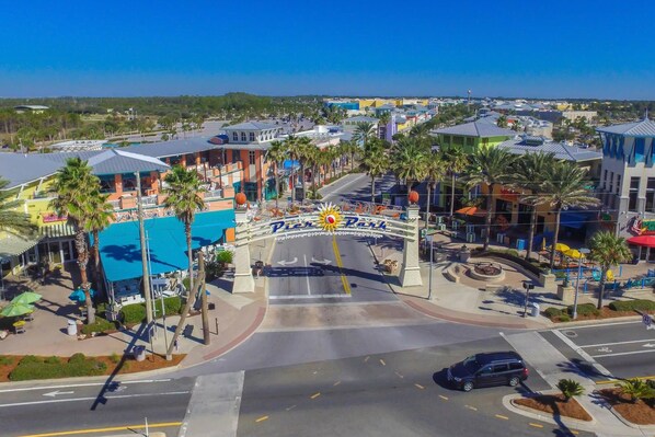 A view of a parking area with a sign reading "Park City Beach - Florida" and a blue sky.