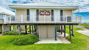 A two-story building with a balcony, a sign reading "Malky Way," and a number "2716" on the side. - Milky Way Beach Front: Coastal Realty Group (Grand Isle)