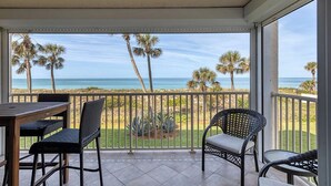 A balcony with a view of the beach and palm trees. - Tiffany Plaza in Longboat Key, FL (Longboat Key)