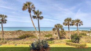 A coastal landscape with palm trees and a view of the ocean. - Tiffany Plaza in Longboat Key, FL (Longboat Key)