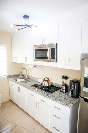 Fridge, microwave, stovetop, coffee/tea maker