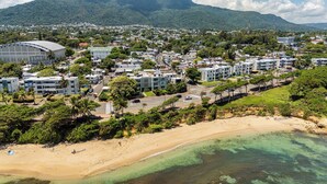 A coastal town with a beach, residential buildings, and a large stadium. - Modern 2BR near beach, dinning, and historic center, in the heart of the city (Puerto Plata)