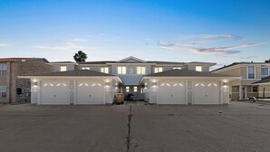 A large, modern building with multiple garage doors and a central entrance.