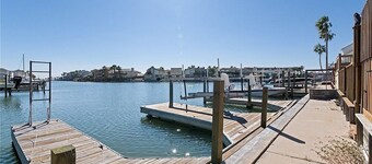 Escape to this waterfront 3 BR condo with a large deck and beautiful canal views