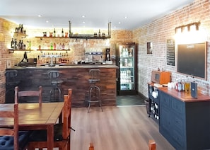 Enjoy a drink at the bar, where a chalkboard menu showcases the selection of specials.