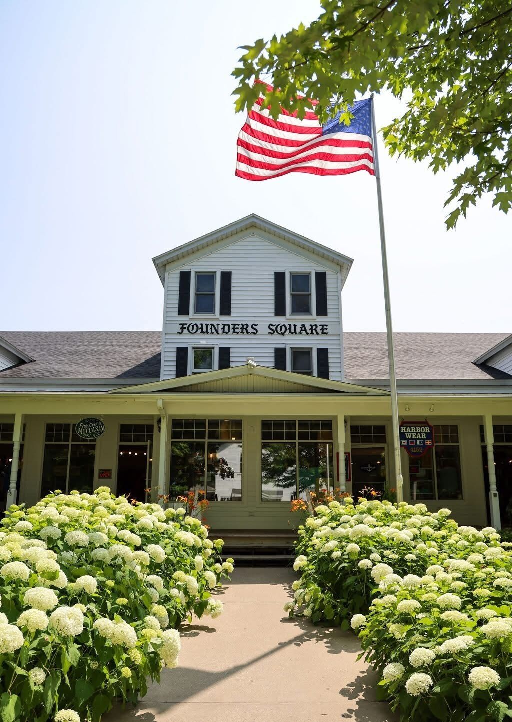 A building named 'Founders Square' with a flagpole and an American flag.