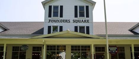 A building named 'Founders Square' with a flagpole and an American flag.