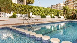 A swimming pool with steps leading into it, surrounded by a white fence and greenery. - Venecia by Interhome (Playa de Aro)