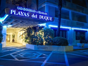 The entrance of a hotel with a sign reading "CASAS CORDOBAY y GRANADA PLAYAS del DUQUE".