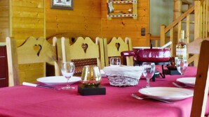 A dining table set with plates, glasses, and a red bowl.