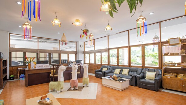 A spacious lobby with a reception desk, plush seating, and decorative hanging lights. - Budget Stars Hotel (Chiang Mai)
