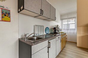 Fridge, microwave, stovetop, coffee/tea maker