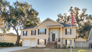 A two-story house with a front porch, a garage, and a flagpole. - Inviting Savannah Vacation Rental w/ Game Room! (Savannah)