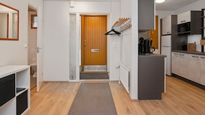 A modern kitchen with white cabinets, a microwave, and a coffee machine. - Mäntyranta 1 by Interhome (Punkaharju)