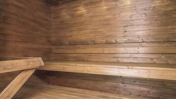 A wooden interior with benches and a sloped ceiling.