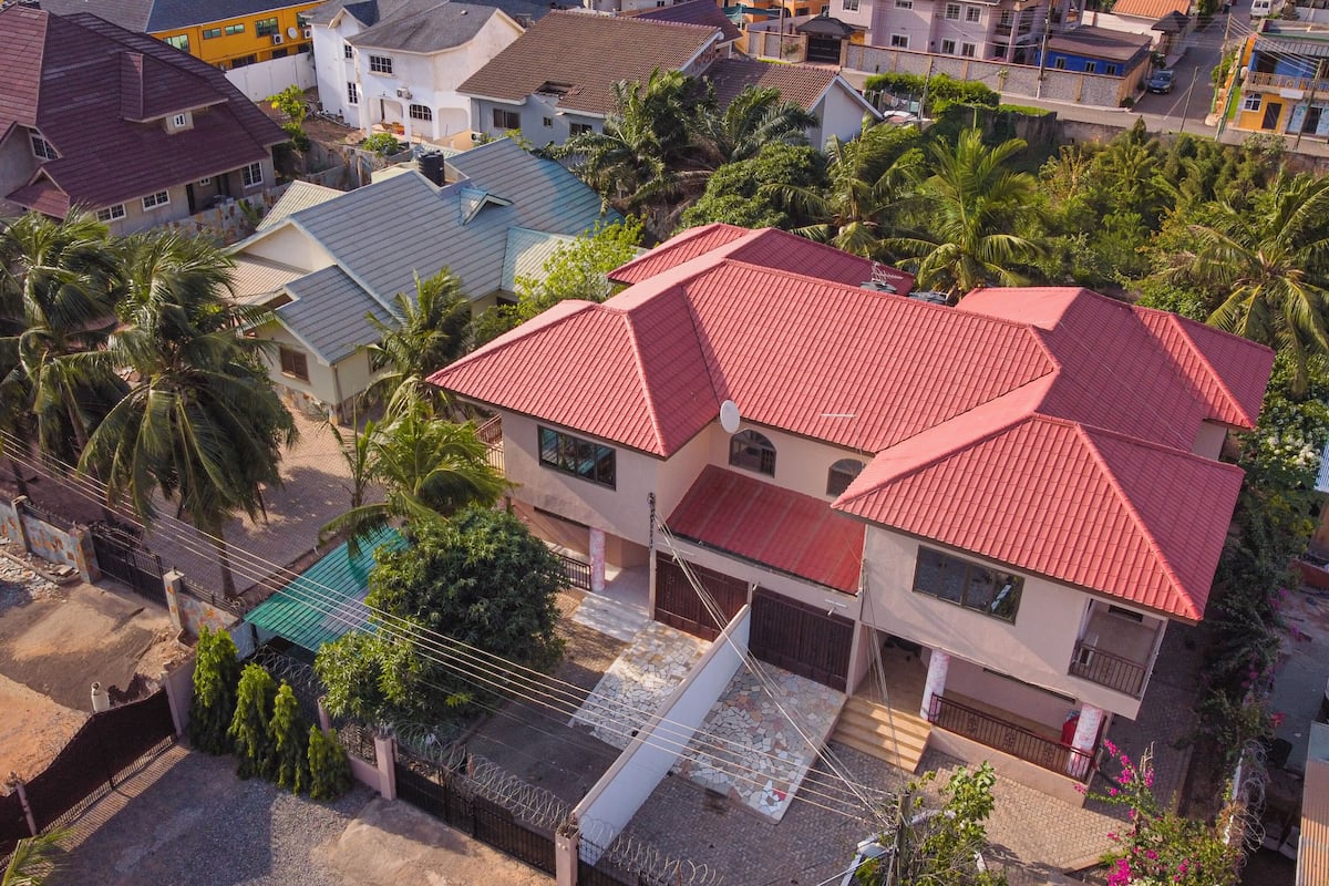 A residential area with houses featuring red roofs and a mix of architectural styles.