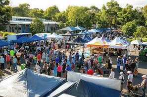 A crowded outdoor market with tents and people. - Bassett House Willunga - An entire spacious home on a tree lined street.  (Willunga)