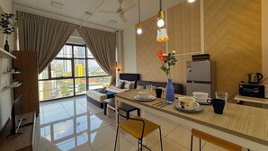 A modern kitchen with a dining area, a large window with curtains, and a view of the city. - 3 Towers Jalan Ampang By Serenity Homes (Kuala Lumpur)