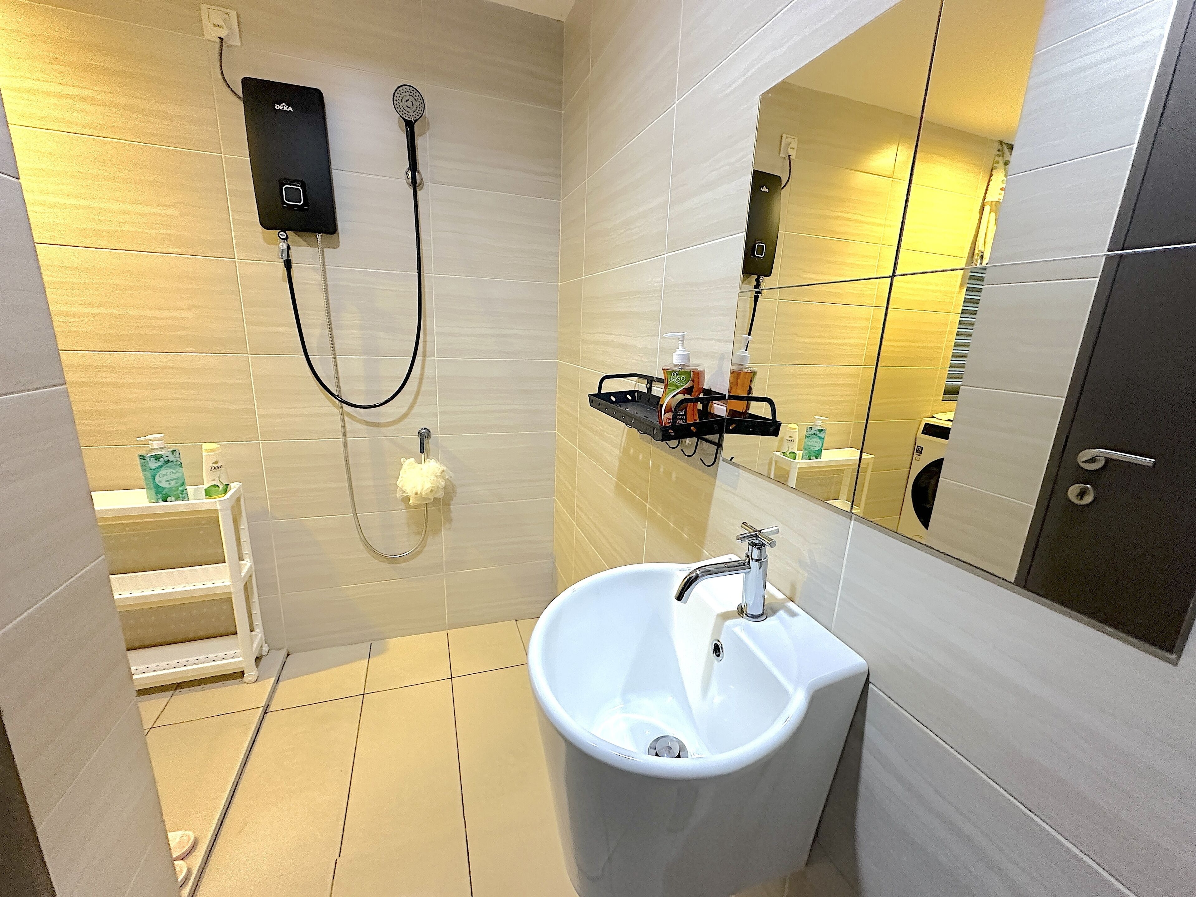A modern bathroom with a white sink, a handheld showerhead, and a mirror.