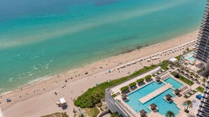 A resort with a large pool, beach area, and ocean view. - Oceanview Balcony|Beachfront Resort|Rooftop Pool (Hollywood)