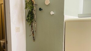 A kitchen with a white refrigerator, a green wall, and a hanging plant. - Two-Bedroom Apartment with Pool, Balcony, and Garage in Tranquil Jaca (Jaca)