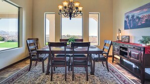 A dining area with a chandelier, a large window, and a view of the landscape. - Las Cruces Home w/ Mountain Views & Private Pool! (Las Cruces)