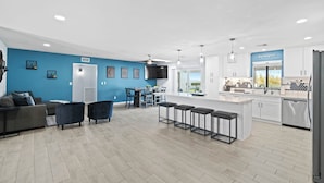 A modern kitchen with a central island, white cabinets, and stainless steel appliances. - Sunny Arizona Oasis w/ Views - 2 Mi to Lake Havasu (Lake Havasu City)