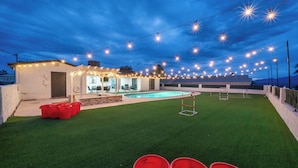 A backyard with a swimming pool, string lights, and red buckets. - Sunny Arizona Oasis w/ Views - 2 Mi to Lake Havasu (Lake Havasu City)