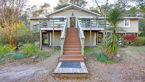 A two-story house with a wooden staircase leading to a front door. - Wilmington Getaway Near Carolina Beach Boardwalk! (Wilmington)