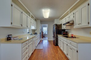 A kitchen with white cabinets, a stainless steel refrigerator, and a microwave. - Lovely Decatur Home w/ Yard ~ 6 Mi to Town! (Decatur)